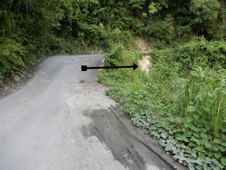 The section of road under scrutiny, with an arrow pointing to the section that is deteriorating. 