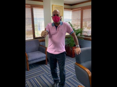 President and CEO, Sagicor Group Jamaica, Christopher Zacca, represents in his pink mask and a pink shirt.
