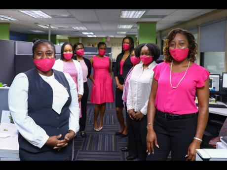 Pretty in pink: These ladies from Sagicor Life’s Client Services and Claims Unit show off their pink masks.