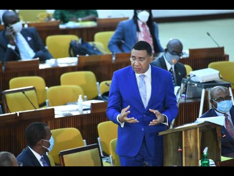 Finance and the Public Service Minister Dr Nigel Clarke looks on as Prime Minister Andrew Holness addresses the House of Representatives on Tuesday. The Government announced that it was hiking its expenditure by roughly $16 billion for fiscal year 2020-202