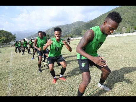 
Members of Jamaica’s national senior football team, the Reggae Boyz, are taken through a stretching exercise during a training session at The University of West Indies (UWI)/Jamaica Football Federation/Captain Burrell Centre of Excellence at UWI on Tues