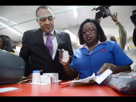 Ernestine Watson, president of the Pharmaceutical Society of Jamaica, seen here with Health Minister Dr Christopher Tufton in February 2017.