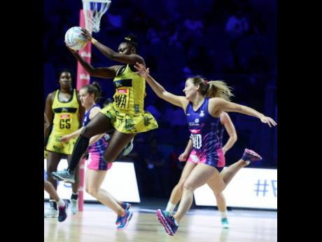 Jamaica’s Khadijah Williams (airborne) receives a pass while under pressure from Scotland’s Kelly Boyle (right) in their Netball World Cup encounter at the M&S Bank Arena in Liverpool on Wednesday, July 17, 2019.