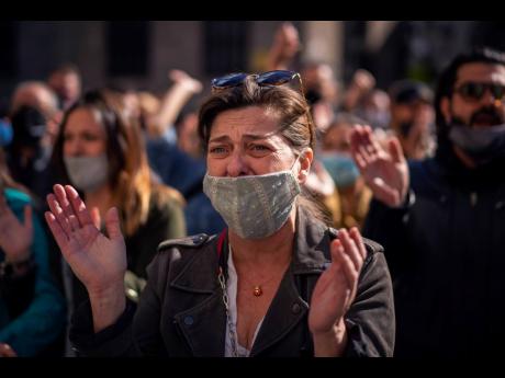 A woman cries during a protest organised by restaurant and bar owners in Barcelona, Spain, yesterday. Authorities in northeastern Spain ordered all bars and restaurants closed for two weeks. 