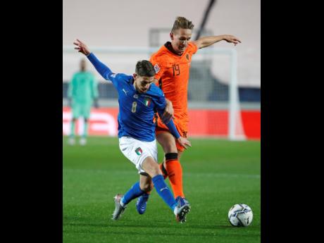 Italy’s Jorginho (left) is challenged by Netherlands’ Luuk De Jong during the UEFA Nations League match between Italy and the Netherlands at Azzurri d’Italia stadium in Bergamo, Italy, Wednesday, yesterday. The match ended 1-1.
