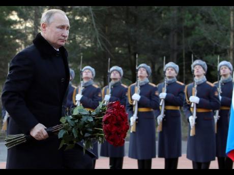 Russian President Vladimir Putin attends a wreath-laying commemoration ceremony for the 77th anniversary since the Leningrad siege was lifted during the World War II at the Boundary Stone monument, around 50 kilometres east of St Petersburg, Russia, on Jan