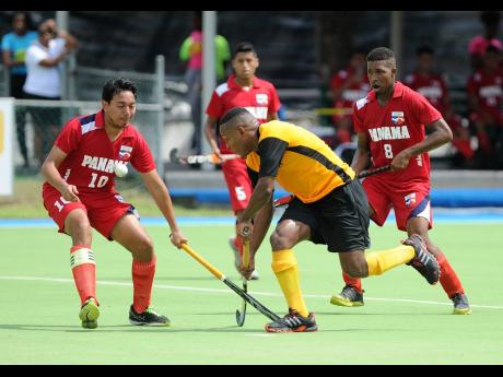 In this file photo from November 2017, Jamaica’s Nicholas Beach (second right) dribbles by (from left) Panama’s Ademir Montenegro, Eduardo Gordon, and Angelo Boodie in their Central American and Caribbean Games qualifier at the Mona Hockey Field.