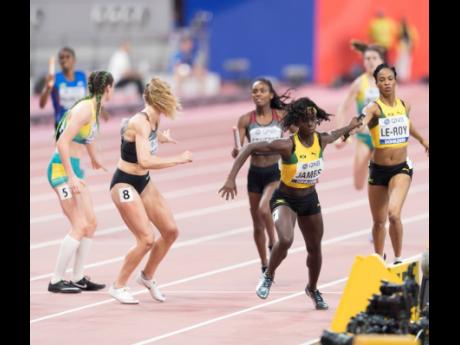 Jamaica’s Anastasia Le-Roy (right) hands off the baton to teammate Tiffany James (second right) during their Women’s 4x400m relay heat at the World Athletics Championships in Doha, Qatar on Saturday, October 5, 2019.
