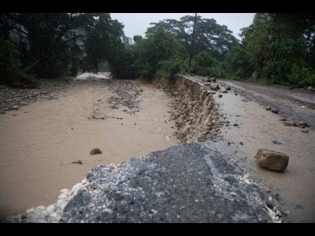 Silt covers the Georgia main road in St Thomas as a section A section of the roadway is being eroded by a river on Friday October 2. The NWA boss has noted the physical damage caused to road by landslides but says most of the roads being eroded across the 