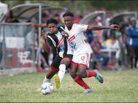 
Ronaldo Webster of Cavalier (left) is tackled by UWI FC’s Nacquain Brown during a Red Stripe Premier League match at the Mona Bowl on Sunday, February 23, 2020.