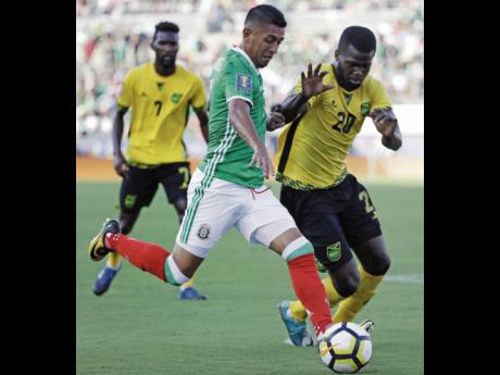 
Jamaica’s Kemar Lawrence (right) challenges Mexico’s Elias Hernandez during a Concacaf Gold Cup semi-final in Pasadena, California, on Sunday, July 23, 2017. 