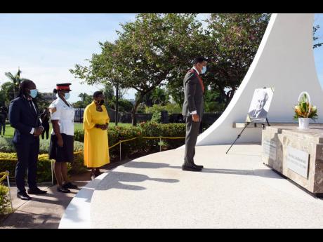 Prime Minister Andrew Holness pays respects to National Hero Sir Alexander Bustamante.