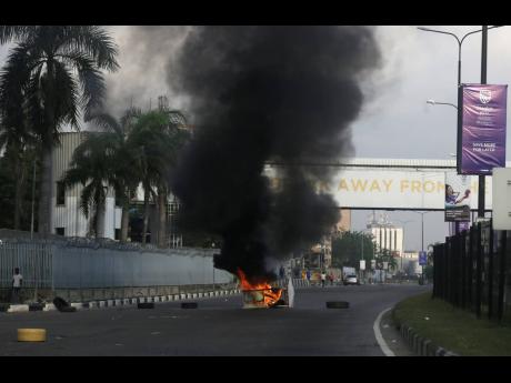 Burning barricades set by protesters against police brutality in Lagos, Nigeria, on Wednesday 