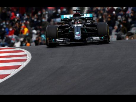 Mercedes driver Lewis Hamilton of Britain on his way to his record-setting 92nd victory during the Formula One Portuguese Grand Prix at the Algarve International Circuit in Portimao, Portugal, yesterday.