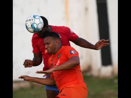 Dunbeholden’s Andre Pryce and Tivoli Gardens’ Newton Sterling (front) come together during a duel for an aerial ball in their National Premier League game at the Edward Seaga Sports Complex on Sunday, October 20, 2019.