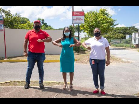 From left: Construction Manager Carnel Campbell, vice-principal Kareen Walters-Brooks and Digicel Foundation CEO Charmaine Daniels stand outside the newly renovated Green Pond Primary and Infant School.