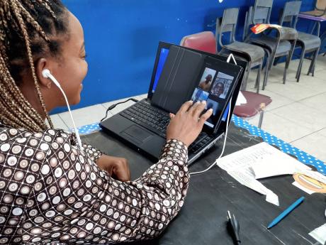 Camecia Vassell, grade six teacher at St Michael’s Primary, interacting with some of her students during an online class. The mother of two says doubling as teacher and mom is driving her “up the wall””.