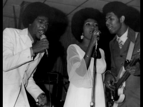 Back in the days: Marcia Griffiths and Bob Andy, assisted by Boris Gardner (right), in performance.