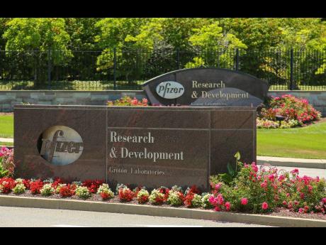 Pfizer signs mounted in front of the Pfizer Research & Development Laboratories in Groton, Connecticut.