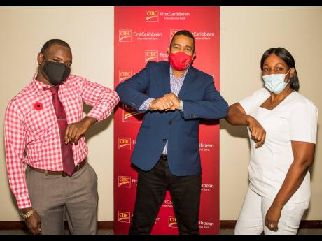 Leslie Bingham (left), senior patient care advocate, University Hospital of the West Indies (UHWI), and Nicola Bright (right), registered nurse/midwife at the Princess Margaret Hospital, St Thomas, celebrate with Nigel Holness, managing director of CIBC Fi