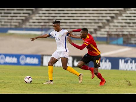 
Waterhouse FC’s Stephen Williams (left) is challenged by CS Herediano’s Keyner Brown during their Scotiabank Concacaf League game played at the National Stadium in Kingston on Thursday, August 22, 2019.