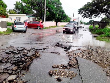 Fresh showers damaged the Yallahs main road in St Thomas on Tuesday.