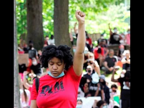Genesis Whitlock is a picture of defiance at a demonstration she planned this summer.