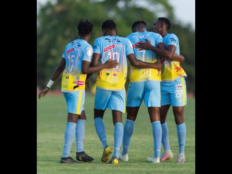 Waterhouse’s Stephen Williams (third form left) celebrates a goal against Real Hope with teammates (from left) Andre Fletcher, Kendroy Howell, and Andre Leslie during the 2019 FlLOW Concacaf Caribbean Club Championhsip at Stadium East on May 14, 2019.