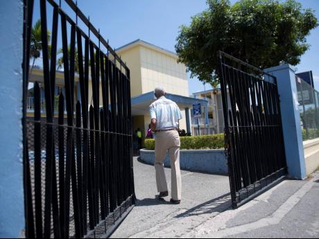 A man entering the gates of the Ministry of Finance, National Heroes Circle, Kingston on March 30, 2020. The Ministry of Finance will host an online paltform, InvestmentMap, that will add transparency to government's spending habits. 