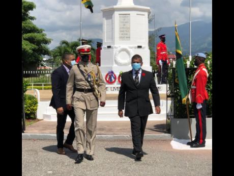 British High Commissioner Asif Ahmad (centre) walks back after laying a wreath at the cenotaph at National Heroes Park in Kingston yesterday in honour of servicemen who fought in World Wars I and II.