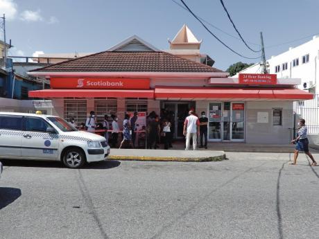 Customers join a queue at Scotiabank in Ocho Rios, St Ann.