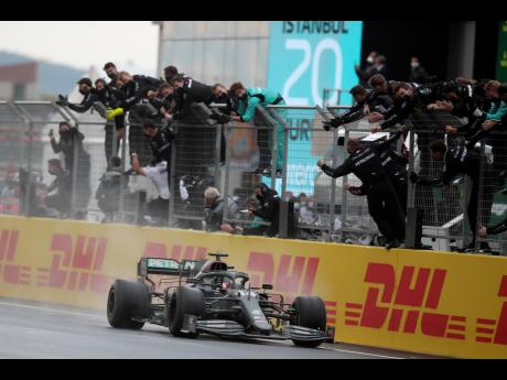 Mercedes driver Lewis Hamilton of Britain crosses the finish line to win the Formula One Turkish Grand Prix at the Istanbul Park circuit racetrack in Istanbul, Turkey, yesterday.