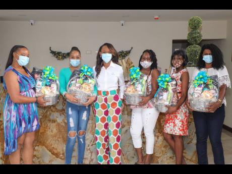 Nurses from the Kingston Public Hospital flank Melia McKitty Plummer (third left), branch manager at Sagicor Life Corporate Circle, following a gift basket presentation to the health professionals. They are (from left) Denise James, Toni Bennett, Ruthlyn W