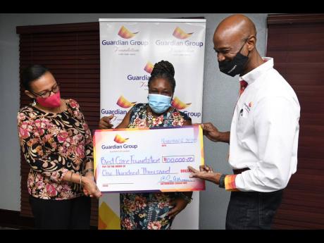 It was a happy day for the Best Care Foundation when Director Maxene Johnson (left) and principal Sharifa Brock-Lewin recently accepted a donation of $100,000 from the Guardian Group Foundation,represented by Michael Waite, insurance adviser, Guardian Life