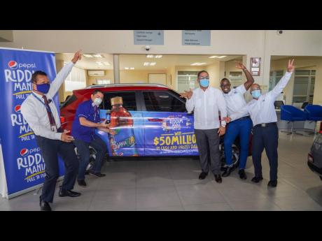 Joining forces: Team Hyundai and Pepsi were excited for the unveiling of the grand prize vehicle – a 2020 Hyundai Venue. From left are: Etus Collman, Michael Lopez Castillo, Jose Melo, Etmour Williams and Erick Gutierrez.