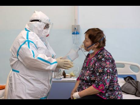 Dr Tatyana Symbelova treats a coronavirus patient on artificial lung respiration at an intensive care unit in the red zone of the hospital in Ulan-Ude, the regional capital of Buryatia, a region near the Russia-Mongolia border, Russia.