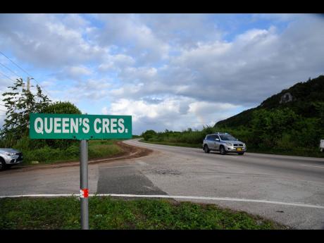 A police service vehicle drives along Queens Highway with the Puerto Bueno Mountain in Discovery Bay, St Ann. A permit was recently granted by the Government of Jamaica for mining and quarrying in the ecologically sensitive area. 