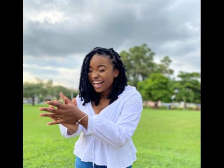 Latoya Robinson’s excitement is palpable as she takes photos on the grounds of The University of the West Indies, Mona campus. Robinson has earned a BSc in accounting. 