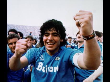 Argentine soccer superstar Diego Armando Maradona cheers after the Napoli team clinched its first Italian major league title in Naples, Italy, on May 10, 1987. Diego Maradona has died. The Argentine soccer great was among the best players ever and who led 