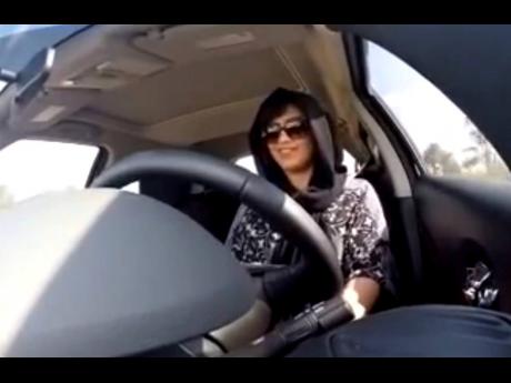 This November 30, 2014 image, made from video released by Loujain al-Hathloul, shows her driving towards the United Arab Emirates-Saudi Arabia border before her arrest on December 1, 2014, in Saudi Arabia. 