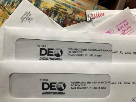 AP
Envelopes from the Florida Department of Economic Opportunity Reemployment Assistance Program are shown on Thursday, November 5, in Surfside, Florida. The number of a Americans applying for unemployment benefits rose last week to 778,000, evidence that 
