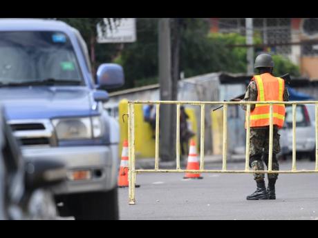 Security personnel at a checkpoint on Mountain View Avenue in east Kingston. 