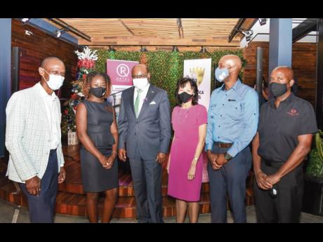 Chris Jarrett (left), chair, Jamaica Hotel and Tourist Association (JHTA) Kingston Chapter; Minister of Tourism, Edmund Bartlett (third left) and JHTA Executive Director, Camille Needham (third right) with JHTA Kingston Chapter COVID-19 Ambassadors: Krysta