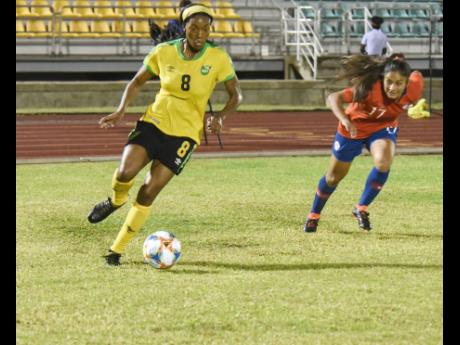 Jamaica’s Cheyna Matthews (left) dribbles away from Chile defender Javiera Toro during their international friendly at the Montego Bay Sports Complex on Sunday, February 28, 2019.