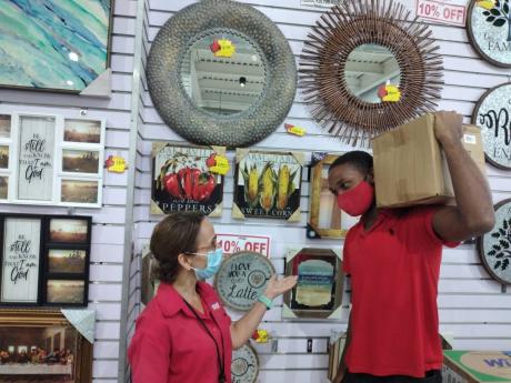 Tahj Daley, a merchandiser in the electronics department at the Azan Supercentre in Cross Roads, St Andrew, receives instructions from his boss, Natalie Debellis, HR and marketing manager. The store is having a three-day sale, benefitting from some of the 