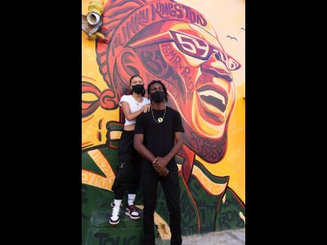 
Joshua Solas (right) and co-painter Anna-Lisa Guthrie, stand by their mural dedicated to late Toots and the Maytals lead singer, Frederick ‘Toots’ Hibbert. The mural was a group effort with Solas, Guthrie, Jaime Grandison, David Francis and Jason Goss