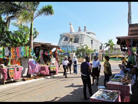 
In this September 26, 2012 photo, the Royal Caribbean’s Allure of the Seas cruise ship is docked in Falmouth, Trelawny, as vendors prepare to sell clothes, souvenirs and other goods to tourists.