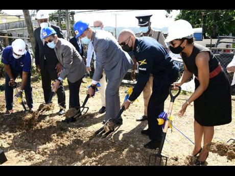 Prime Minister Andrew Holness (third right) and National Security Minister Dr Horace Chang (third left) break ground for the construction of a new police station in Mt Salem, St James. Other persons in the photo are (from left) Omar Sweeney, managing direc