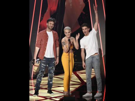 In this March 2017 file photo, Alex Pall, left, and Drew Taggart, right, of the Chainsmokers, and Halsey accept the award for dance song of the year for ‘Closer’ at the iHeartRadio Music Awards.