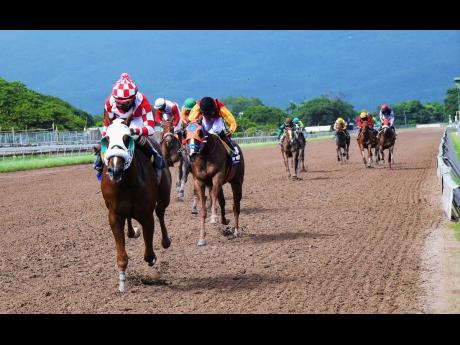 FURTHER AND BEYOND, ridden by Dane Nelson, wins the fourth race at Caymanas Park, in Portmore, St Catherine, on Saturday, October 24.
